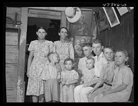 French village, a small settlement on Saint Thomas Island, Virgin Islands. French family living in one of the tiny houses in the French village, a small settlement. Several of the children suffer from an eye disease that necessitates a delicate operation possible only in the United States. Sourced from the Library of Congress.