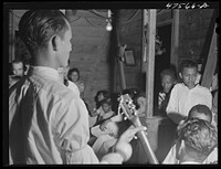 [Untitled photo, possibly related to: Guanica, Puerto Rico (vicinity). At a Three Kings' eve party in a tenant farmer's home in the sugar country]. Sourced from the Library of Congress.