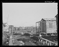 [Untitled photo, possibly related to: San Juan, Puerto Rico. In the slum area known as "El Fangitto" ("the mud")]. Sourced from the Library of Congress.