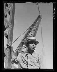 [Untitled photo, possibly related to: San Sebastian, Puerto Rico (vicinity). President of a FSA (Farm Security Administration) crane cooperative. There are thirteen members collectively using this crane for loading their sugar cane]. Sourced from the Library of Congress.