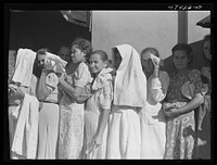 Cabo Rojo, Puerto Rico. Waiting in line at the surplus commodities office. Fatback and meal were distributed that day. Sourced from the Library of Congress.