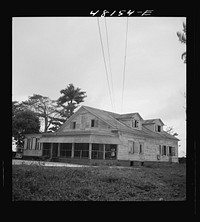 Santurce, Puerto Rico (vicinity). A house on the property which FSA (Farm Security Administration) is buying for a land and utility housing project. Sourced from the Library of Congress.