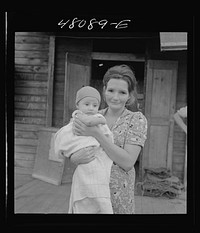 [Untitled photo, possibly related to: San Juan, Puerto Rico. Mother and child in the slum area known as "El Fangitto"]. Sourced from the Library of Congress.