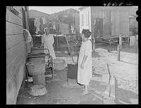 San Juan, Puerto Rico. Washing clothes in a back yard in El Fangitto, a slum area. Sourced from the Library of Congress.