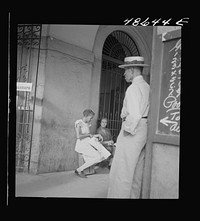 [Untitled photo, possibly related to: San Juan, Puerto Rico. Selling lottery tickets on the street]. Sourced from the Library of Congress.