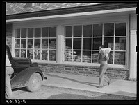 Roofing materials and flour in window of community store. Tygart Valley project, West Virginia. Sourced from the Library of Congress.