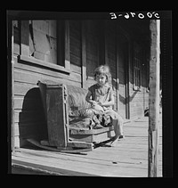 [Untitled photo, possibly related to: Child on front porch in abandoned mining town. Jere, West Virginia. See 30221-M1]. Sourced from the Library of Congress.