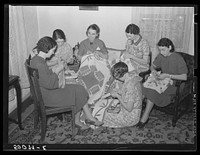Housewives in Tygart Valley, West Virginia, have weekly group meetings in home economics. Here they are quilting. Sourced from the Library of Congress.