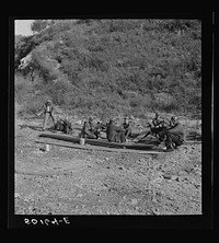 [Untitled photo, possibly related to: Coal miners waiting along road for bus to take them home. In Welch, Bluefield section, West Virginia]. Sourced from the Library of Congress.