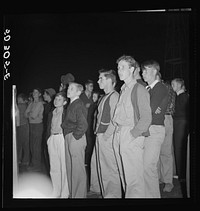 Coal miners' sons watch aerial trapeze artists at outdoor carnival. Large event and only amusement during year. Granville, West Virginia. Sourced from the Library of Congress.