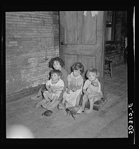Mexican miner's children feeding chickens in the kitchen. Their mother is thirty years old and has had ten children. Scotts Run, Bertha Hill, West Virginia. Sourced from the Library of Congress.