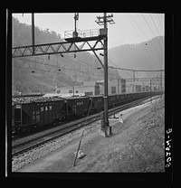 Coal cars going through center of mining town. Davey, West Virginia. Sourced from the Library of Congress.
