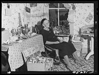 Mrs. Myrtle Higgins of Leraysville, New York, with some of the belongings she has packed preparing to move out of the area being taken over by the Army. Mrs. Higgins has been selling eggs and berries in the town and her son added to her two dollar a week income by working in a junk yard in Watertown, New York. She is moving to a farm near Mexico, New York. Sourced from the Library of Congress.