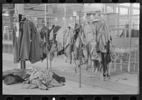 [Untitled photo, possibly related to: Half-made garments on the racks, awaiting final operations of the machines, in cooperative garment factory, Hightstown, New Jersey] by Russell Lee