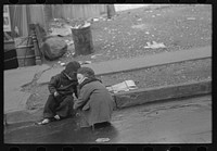 Children playing in the gutter on 139th Street just east of St. Anne's Avenue, Bronx, New York by Russell Lee