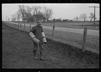 Tip Estes carrying tiles to load on a wagon, Fowler, Indiana by Russell Lee