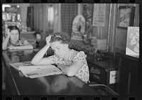 Girl reading newspaper in restaurant bar, Tower, Minnesota by Russell Lee