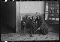 Men talking in the Great Northern Hotel, Williston, North Dakota by Russell Lee