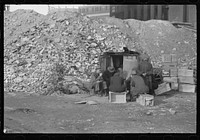 [Untitled photo, possibly related to: Unemployed workers in front of a shack with Christmas tree, East 12th Street, New York City] by Russell Lee