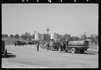 [Untitled photo, possibly related to: Loading liquid feed onto truck from tanks at distillery near Owensboro, Kentucky] by Russell Lee