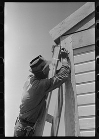 [Untitled photo, possibly related to: Southeast Missouri Farms Project. Finishing off corner board of one of the new houses] by Russell Lee