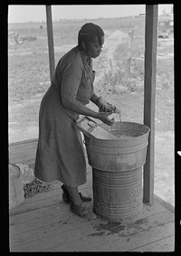 Wife of sharecropper washing clothes, Southeast Missouri Farms by Russell Lee