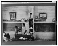 Schoolteacher explaining passage to pupil, La Forge, Missouri. School attended by Southeast Missouri Farms children by Russell Lee