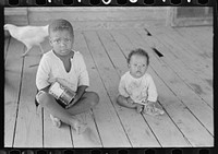Background photograph. Children of FSA (Farm Security Administration) client who will become owner-operator under tenant purchase program, Missouri by Russell Lee