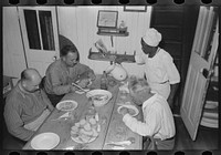 Dinner in the galley of the El Rito, packet boat, Louisiana by Russell Lee