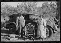Migrant cane chair maker and wife in front of their automobile home, near Paradis, Louisiana by Russell Lee