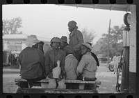 [Untitled photo, possibly related to: Cotton pickers boarding truck which will take them to the fields, Pine Bluff, Arkansas] by Russell Lee