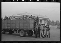 [Untitled photo, possibly related to: Cotton pickers boarding truck which will take them to the fields, Pine Bluff, Arkansas] by Russell Lee