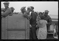 [Untitled photo, possibly related to: Helping women cotton pickers board truck, Pine Bluff, Arkansas] by Russell Lee