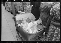 [Untitled photo, possibly related to: Two children in buggy, National Rice Festival, Crowley, Louisiana] by Russell Lee