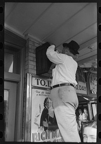 [Untitled photo, possibly related to: Arranging prizes to be awarded at game concession, National Rice Festival, Crowley, Louisiana] by Russell Lee