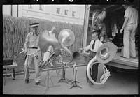 Members of Southwestern University band unloading instruments from truck, National Rice Festival, Crowley, Louisiana by Russell Lee