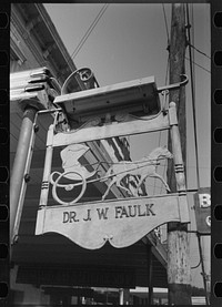 Sign in front of doctor's office, symbol of the horse and buggy doctor, Crowley, Louisiana by Russell Lee