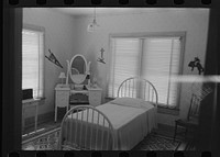 Bedroom of daughter of wealthy Cajun farmer, Jospeh La Blanc, near Crowley, Louisiana by Russell Lee