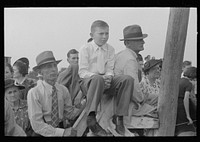 Group of people watching ceremonies on main platform, state fair, Donaldsonville, Louisiana by Russell Lee
