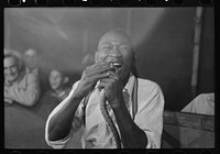 Man biting snake at sideshow, state fair, Donaldsonville, Louisiana by Russell Lee