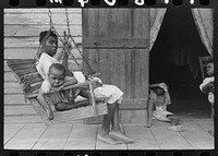 Mother with children on porch of home near Paulina, Louisiana by Russell Lee