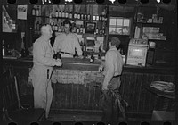 Drinking at the bar in general store, Olga, Louisiana by Russell Lee