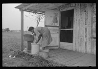 [Untitled photo, possibly related to: es talking on porch of small store near Jeanerette, Louisiana] by Russell Lee