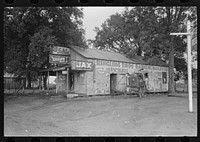 [Untitled photo, possibly related to: Horse and buggy standing in front of store near Lafayette, Louisiana] by Russell Lee