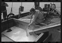 Loading shaved ice into shrimp boat, Morgan City, Louisiana by Russell Lee