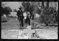 couple at grave of relative, All Saints' Day in Cemetery at New Roads, Louisiana by Russell Lee