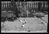 [Untitled photo, possibly related to: Decorated graves in cemetery, All Saints' Day, New Roads, Louisiana, with chickens eating the flowers] by Russell Lee