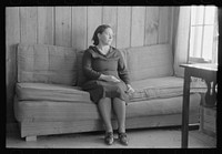 [Untitled photo, possibly related to: Wife of Chicot Farms homesteader sitting on homemade sofa, Chicot Farms, Arkansas] by Russell Lee