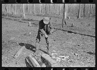 [Untitled photo, possibly related to: Farmer of Chicot Farms, Arkansas striking match on button of overalls] by Russell Lee