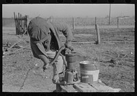 [Untitled photo, possibly related to: Children of  sharecropper pumping water. Family will be resettled at Transylvania Project, Louisiana] by Russell Lee